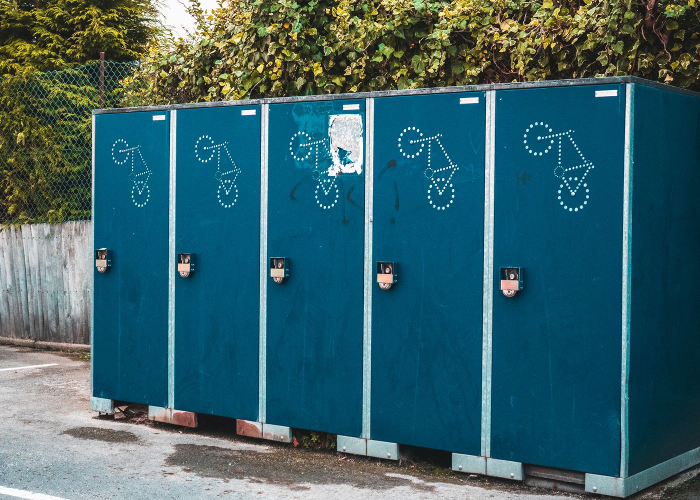 Blue portable toilets arranged in a row outdoors