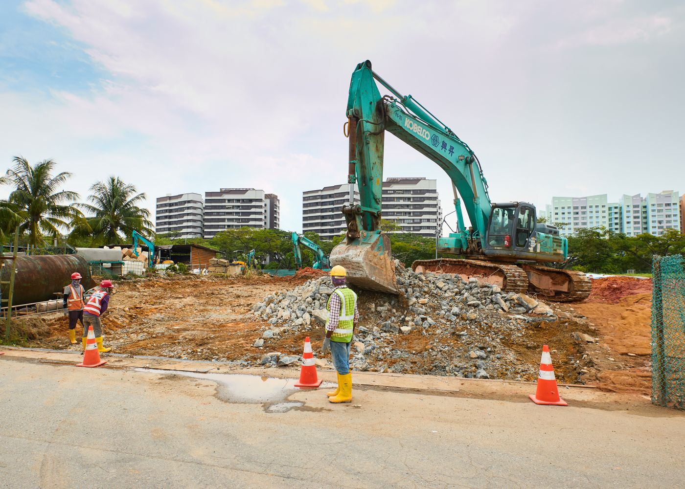 Excavators and workers at an active construction site